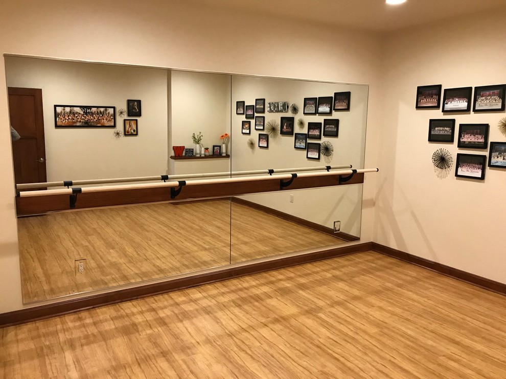 ballet room with mirrored wall and bar